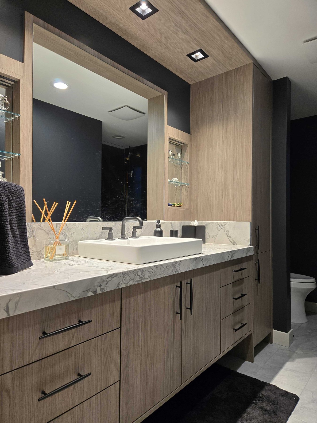 Contemporary bathroom vanity with a veined stone countertop