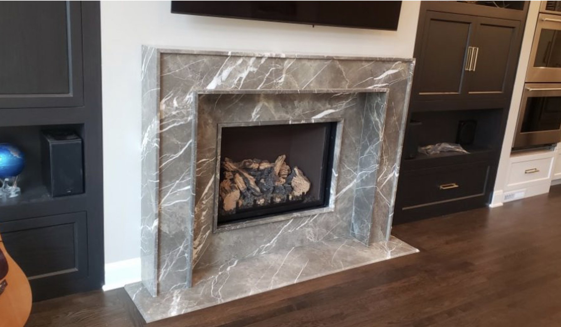 Finished gray marble fireplace surround with layered dimensional trim