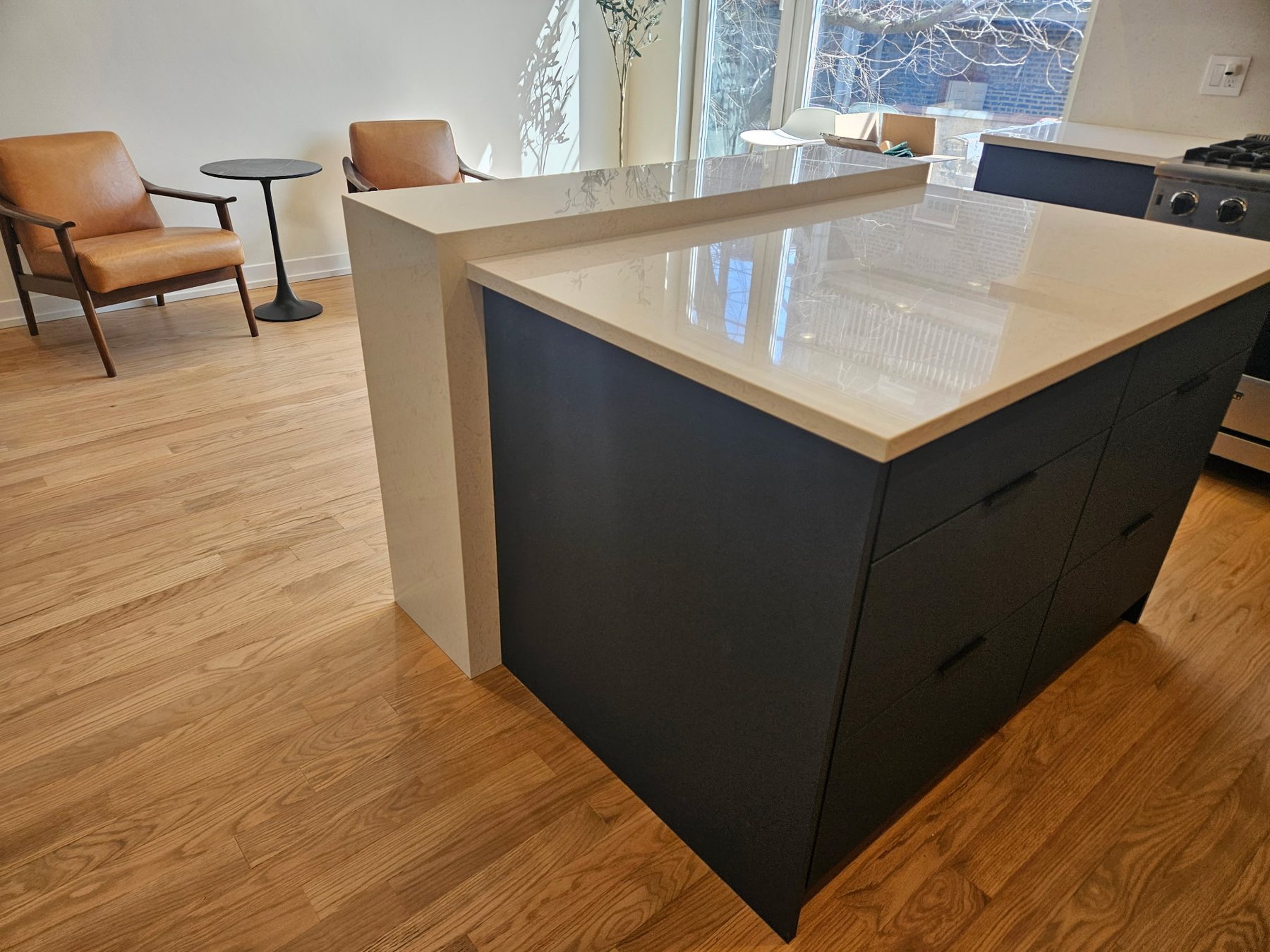 Modern two-tone kitchen island with polished stone countertops